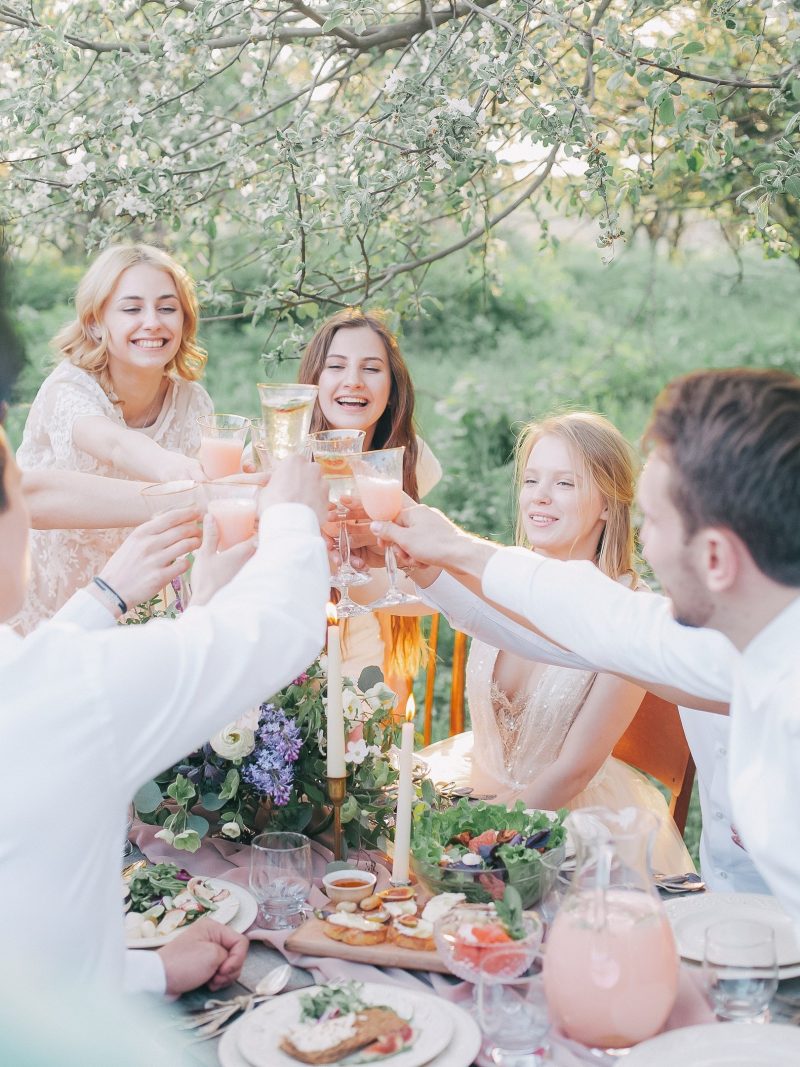 Friends around a table raising a toast