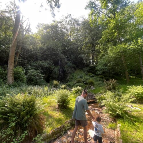 Dad and son walking through the water at Hestercombe House and Gardens